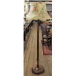 An Edwardian stained beech standard lamp, with fluted column on circular base,