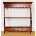 A mahogany hanging rack, with two shelves and three drawers,