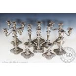 A set of ten silver plated candlesticks and candelabra,