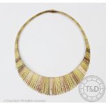 A tri-colour yellow gold necklace, the graduated fringe necklace with textured finish throughout,