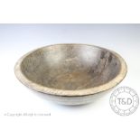 A 19th century vernacular turned sycamore dairy bowl of large proportions, old rivet repair,