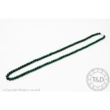 A single strand Malachite bead necklace, the uniform strand with screw clasp,