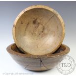 A 19th century vernacular turned elm dairy bowl, with old rustic rivet repairs,