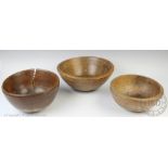 Three 19th century vernacular turned wood dairy bowls, comprising two sycamore examples, largest 28.