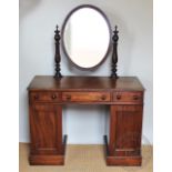 An early Victorian mahogany dressing table, with oval mirror back,