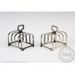 A pair of Edwardian silver toast racks, Mappin & Webb, Sheffield 1904, each of rectangular form,