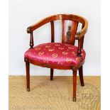 An Empire style mahogany tub chair, late 19th century, with brass mounted splat and scroll end arms,