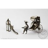 A Dutch novelty silver miniature, early 20th century, designed as children playing on a slide, 4.
