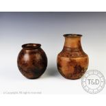 An African earthenware vase of globular form with a burnished mottled ground patina,