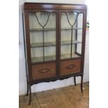 An Edwardian mahogany inlaid display cabinet on tapered square legs,