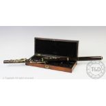 A Dalmaine & Co rosewood flute within fitted rosewood case,