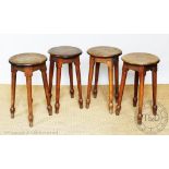 A set of four oak stools, early 20th century, bearing label for 'B Goodall, Burton on Trent',
