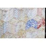 A patchwork quilt, early 20th century, with radiating kite shaped patches,