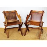 A pair of mid 20th century oak Glastonbury chairs, with solid seats, 85cm H,