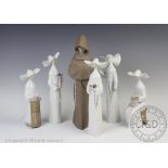 A collection of six Lladro figures, comprising six nuns and a monk,