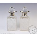 A pair of silver mounted cut glass decanters, D.