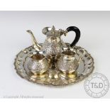 A white metal three piece bachelors tea service, possibly Mexican,