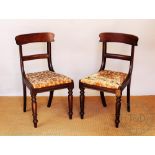 A set of four Victorian carved walnut dining chairs, with upholstered seats,