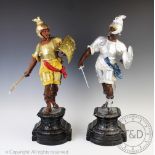 A pair of Victorian spelter figures of warriors, on shaped plinths and ebonised wood bases,
