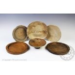 Two late 18th/ early 19th century turned treen circular kitchen coasters of dished form,