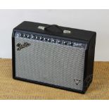 A Fender Deluxe amp, type PR772, Number B-409628, with pedal board.