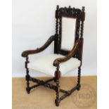 A Carolean style carved oak arm chair, 19th century,