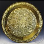 An Indian embossed brass dish of large proportions, decorated with foliate motifs, 90cm diam,