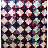 A patchwork quilt, in Log Cabin design,