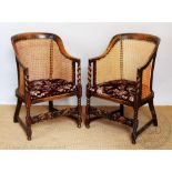 A pair of 1920's beech caned tub chairs, with curved backs and barley twist and block legs,