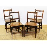 A set of four George III country oak kitchen chairs, possibly Welsh, with solid seats,