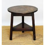 An 18th century style oak cricket table, with circular top and under tier,