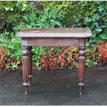 A stained pine railway station table, with moulded top, on turned and gadrooned tapered legs,