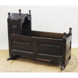 An 18th century oak cradle, 80cm high Provenance: Clynog Farmhouse,