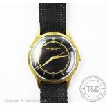 A Baume & Mercier gold plated watch 1962, the circular black dial with gilt batons,