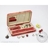 A selection of jewellery to a pink suede jewellery case, to include; three 9ct gold rings,