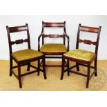 A set of six Regency style mahogany dining chairs, with drop in seats, on sabre legs, 87cm H,