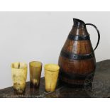 A coopered ale jug or pitcher 33cm high and three horn beakers (4) Provenance: Clynog Farmhouse,
