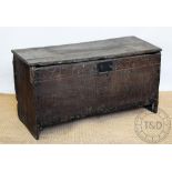 A 16th / 17th century oak six plank coffer, of large proportions, with carved frieze and top,