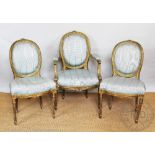 A Louis XVI style carved gilt wood and gesso fauteuille, with blue upholstery,