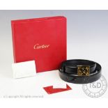 A Cartier ladies black leather belt with gold coloured rectangular buckle,