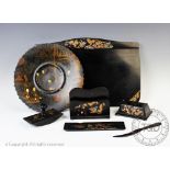 A Chinese lacquered papier mache desk set, six pieces, decorated with dragons, blotter 44cm wide,