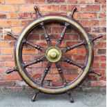 A brass mounted stained wood ships wheel, eight spoke,