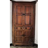 An impressive George III oak corner cabinet,