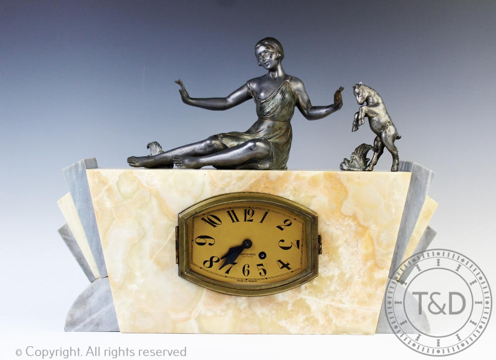 An Art Deco marble and spelter mantle clock, surmounted with a maiden and a goat,