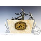 An Art Deco marble and spelter mantle clock, surmounted with a maiden and a goat,