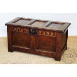 An 18th century oak coffer, with triple panelled top and front, on stile feet,