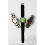 Three Seiko 5 day/date wristwatches, to include; an Automatic green faced example,