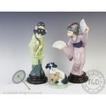 Two Lladro figures of geisha, one holding two fans, 29cm high, the other with a parasol, 28cm high,