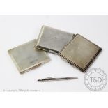 Three silver cigarette cases, each of rectangular shape and with engine turned detailing,