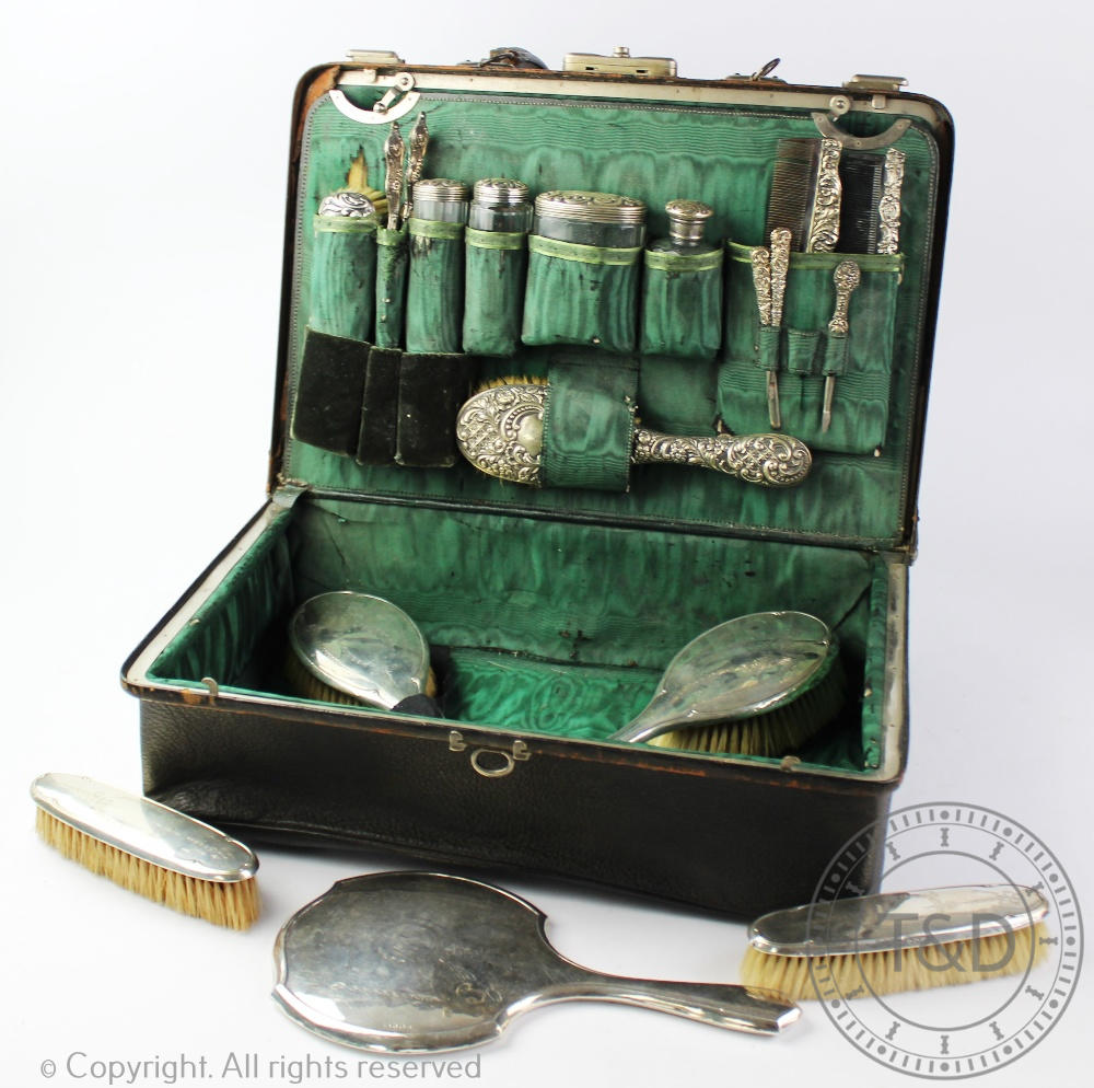 An early 20th century assembled silver travelling dressing case of Gladstone type, initialled S.H.